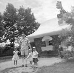 Barbara, Dad, me, and Danny in front of the third little pig house at Enchanted Forest